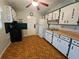 Traditional kitchen featuring white cabinets with decorative pulls, wood countertops, and classic appliances at 919 Timor Ave, Orlando, FL 32804