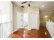 Upstairs hallway with hardwood floors and doors to bathroom and bedrooms at 496 Mile Post Ct, Lake Mary, FL 32746