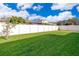 Private backyard with grassy area and white fence at 10063 Malmsbury Rd, Orlando, FL 32829