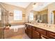 Double vanity bathroom with soaking tub and shower at 10063 Malmsbury Rd, Orlando, FL 32829