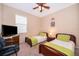 Bedroom with two twin beds and a ceiling fan at 10063 Malmsbury Rd, Orlando, FL 32829