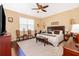 King-size bedroom with wood floors and plenty of light at 10063 Malmsbury Rd, Orlando, FL 32829