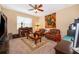 Cozy Gathering room featuring leather armchairs and a large window at 10063 Malmsbury Rd, Orlando, FL 32829