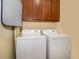 Bright laundry room with washer, dryer, and ample cabinetry at 10063 Malmsbury Rd, Orlando, FL 32829