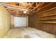 Unfinished garage with overhead door and ample shelving at 543 Warrenton Rd # 543, Winter Park, FL 32792