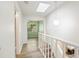 Bright hallway with light wood floors, skylight, and access to other rooms at 543 Warrenton Rd # 543, Winter Park, FL 32792