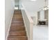 Stylish wooden staircase leading to the upper level at 543 Warrenton Rd # 543, Winter Park, FL 32792