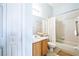 Well-lit bathroom with a shower/tub combo and wood cabinets at 9868 Montclair Cir, Apopka, FL 32703