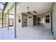 Spacious covered patio with ceiling fan, screen enclosure, and access to backyard at 9868 Montclair Cir, Apopka, FL 32703