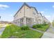 Two-story townhome with gray and beige siding, landscaped yard, and walkway at 3838 Knotty Pine St, Saint Cloud, FL 34772