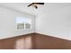 Well lit bedroom with wood floor and a ceiling fan with a window looking outside at 3010 San Jacinto Cir # 3010, Sanford, FL 32771