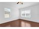 Bright bedroom features hardwood floors, ceiling fan, and large windows at 3010 San Jacinto Cir # 3010, Sanford, FL 32771