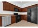 Modern kitchen featuring stainless steel appliances, wood cabinets, neutral counters, and a black refrigerator at 3010 San Jacinto Cir # 3010, Sanford, FL 32771