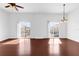 Bright living room with hardwood floors, ceiling fan, pendant light, and two sliding glass doors providing natural light at 3010 San Jacinto Cir # 3010, Sanford, FL 32771
