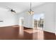 Inviting living room showcasing hardwood floors, ample natural light from two large sliding glass doors, and ceiling fans at 3010 San Jacinto Cir # 3010, Sanford, FL 32771