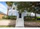 Inviting entrance with steps leading to a front door framed by well-manicured landscaping at 621 Brandy Oaks Loop, Winter Garden, FL 34787