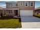 Charming two-story home featuring a welcoming front porch and a two car garage at 3558 Sandalwood Isle Way, Ocoee, FL 34761