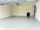 This spacious garage offers a clean, modern look with epoxy floors, storage cabinet, and a unique light fixture at 4009 Winding Meadows St, Apopka, FL 32712