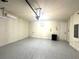 Large garage boasts epoxy flooring, pendant lighting, utility sink, and direct access to the home's interior at 4009 Winding Meadows St, Apopka, FL 32712