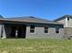 Backyard view with a covered patio, a lawn, and windows that let natural light in at 1173 Basalt Ln, Sanford, FL 32771