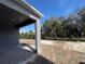 Exterior backyard view with gray pillars and a yard at 1173 Basalt Ln, Sanford, FL 32771