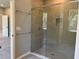 Bathroom showcasing tiled shower with glass doors, providing natural light and sleek design at 1173 Basalt Ln, Sanford, FL 32771