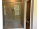 Modern bathroom featuring a glass enclosed shower with window and recessed shower caddy at 1173 Basalt Ln, Sanford, FL 32771