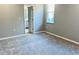 Bedroom with neutral walls, carpet and features an open door to the ensuite bathroom and a window at 1173 Basalt Ln, Sanford, FL 32771