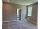 Bedroom with plush gray carpet, en suite bath and a bright sunny window at 1173 Basalt Ln, Sanford, FL 32771