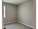 Cozy bedroom features a neutral color scheme with gray walls and carpet, and a window at 1173 Basalt Ln, Sanford, FL 32771
