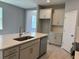 Open kitchen with island, stainless steel appliances, and modern cabinets at 1173 Basalt Ln, Sanford, FL 32771