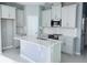 Bright kitchen with stainless steel appliances, white cabinets and a large kitchen island at 1173 Basalt Ln, Sanford, FL 32771