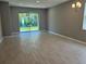Spacious living room with wood floors and sliding glass doors to the outside at 1173 Basalt Ln, Sanford, FL 32771