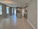 Open concept living area with wood look tile flooring, an island, and gray cabinets at 1173 Basalt Ln, Sanford, FL 32771