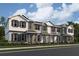 Modern three-story townhome with gray siding at 15369 Burgtheater Dr, Winter Garden, FL 34787