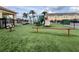 Community playground with a new colorful jungle gym, a balance beam, and synthetic turf at 2878 Club Cortile Cir # A, Kissimmee, FL 34746