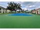 Overhead view of a community tennis court featuring new surfacing and dark green fencing at 2878 Club Cortile Cir # A, Kissimmee, FL 34746