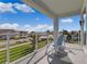 Balcony overlooking the street and ocean, with two chairs at 4260 S Atlantic Ave, Port Orange, FL 32127