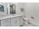 Modern bathroom with gray marble vanity, tiled floor, and a toilet at 4260 S Atlantic Ave, Port Orange, FL 32127