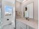 Bathroom with toilet and vanity with granite countertop at 4260 S Atlantic Ave, Port Orange, FL 32127