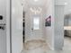 Bright entryway with tile floors, barn door, and modern lighting at 4260 S Atlantic Ave, Port Orange, FL 32127