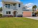 Two-story house with balcony, coral garage door, and lush green lawn at 4260 S Atlantic Ave, Port Orange, FL 32127