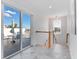 Hallway with tiled floors, wooden staircase, and access to a balcony at 4260 S Atlantic Ave, Port Orange, FL 32127