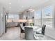 Modern kitchen with gray cabinets, stainless steel appliances, and a breakfast nook at 4260 S Atlantic Ave, Port Orange, FL 32127