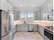 Modern kitchen with stainless steel appliances and gray cabinets at 4260 S Atlantic Ave, Port Orange, FL 32127