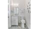Small powder room with white vanity, marble countertop, and decorative wall accents at 4260 S Atlantic Ave, Port Orange, FL 32127