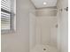 Bathroom showcasing an enclosed shower with tiled walls, white shower rod, and gold hardware at 101 E Division St, Clermont, FL 34711