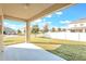 View of the backyard with white fence and grass from the covered patio area at 2563 Lamar Valley St, Apopka, FL 32703
