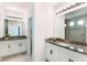 Dual vanity bathroom with granite countertops, tiled flooring, and modern lighting at 2563 Lamar Valley St, Apopka, FL 32703