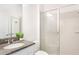 Bright bathroom featuring a glass-enclosed shower, granite countertops, and modern fixtures at 2563 Lamar Valley St, Apopka, FL 32703